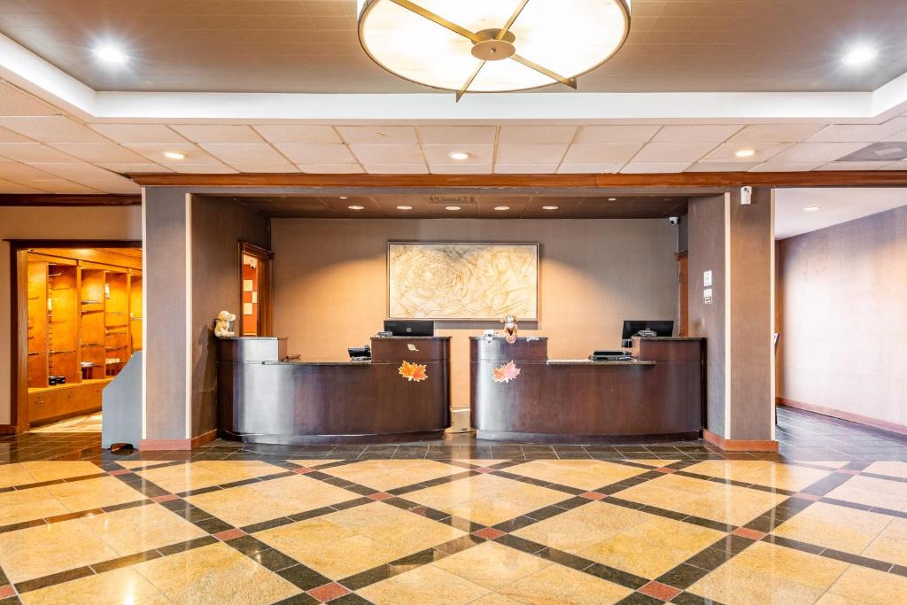 a lobby of a hotel with two reception desks at Wyndham Omaha Hotel - West Dodge in Omaha
