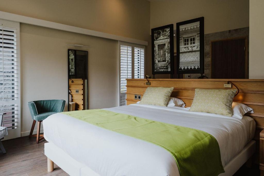 Postel nebo postele na pokoji v ubytování Sarana Hôtel & Spa
