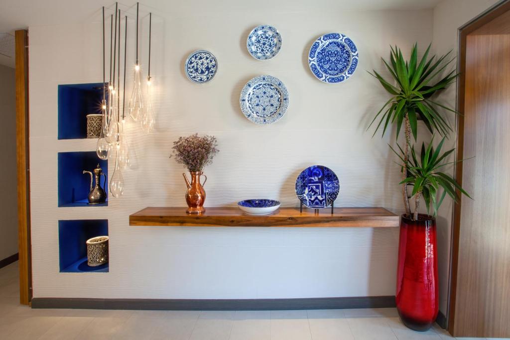 a wall with blue and white plates on a wall at The Marmara Taksim in Istanbul