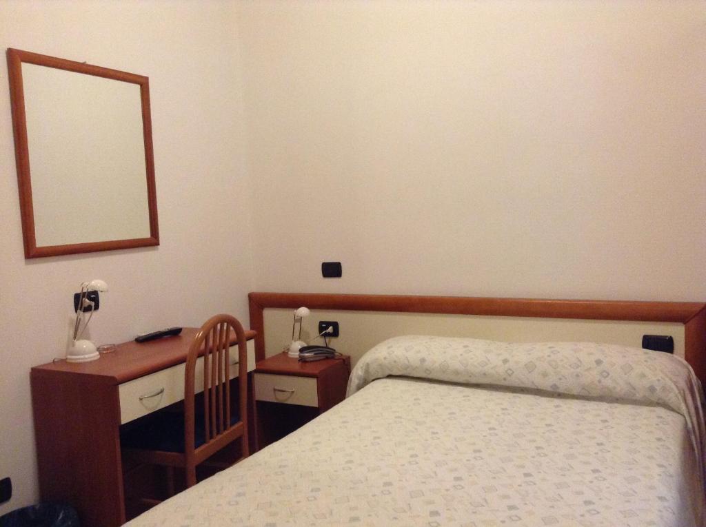 Postel nebo postele na pokoji v ubytování Hotel Ricci