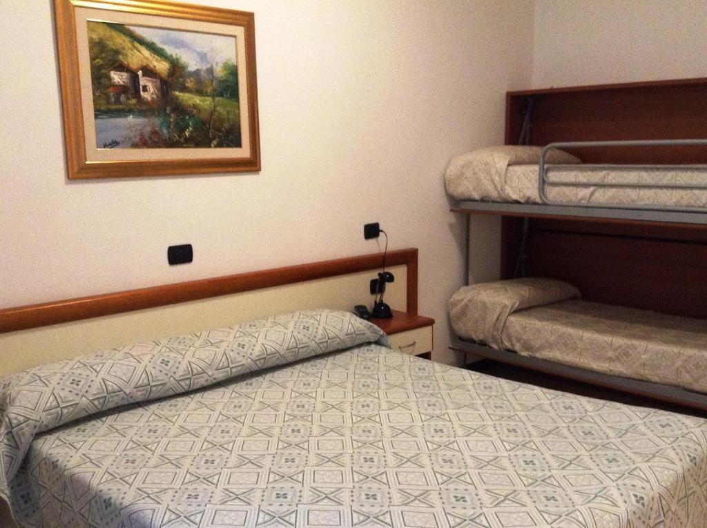 Postel nebo postele na pokoji v ubytování Hotel Ricci