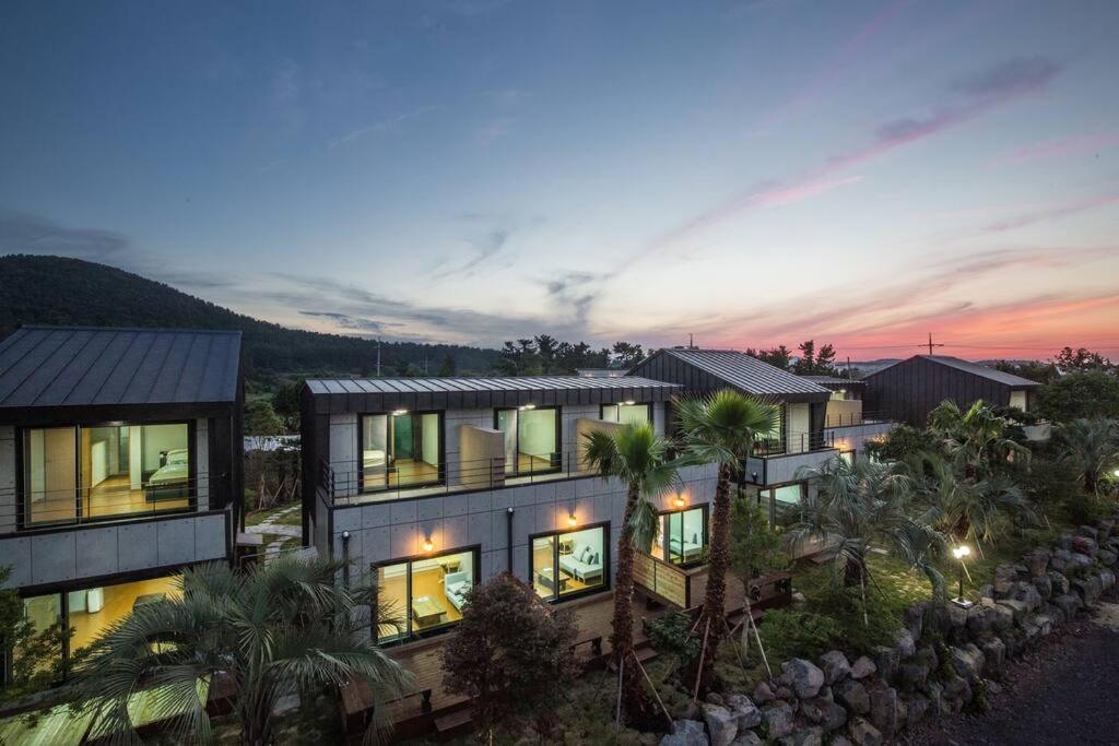 an aerial view of a house at dusk at THE SOME PENSION in Seogwipo