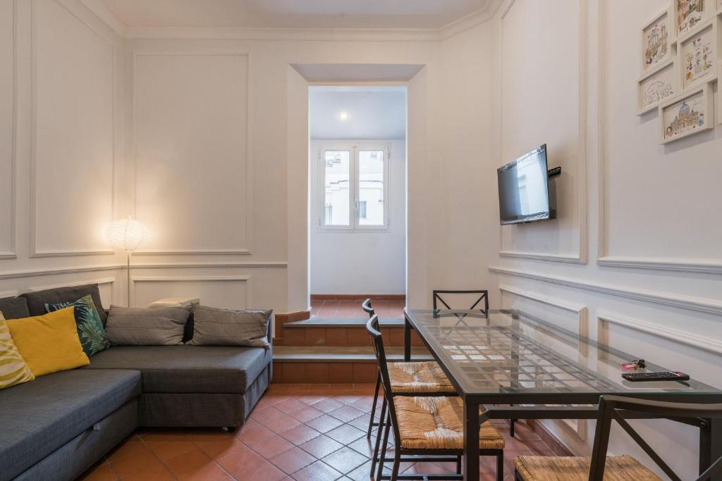 a living room with a couch and a table at JOIVY Modern Flat near Spanish Steps in Rome