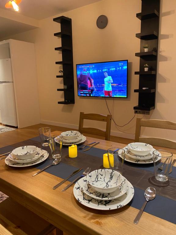 a dining room table with plates and utensils on it at Modern and New Family flat in Beylikdüzü in Beylikduzu