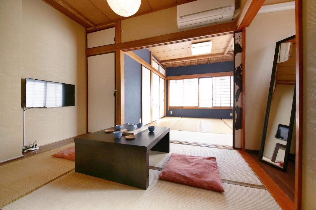 a living room with a black table and a large window at Tamanoi in Tokyo