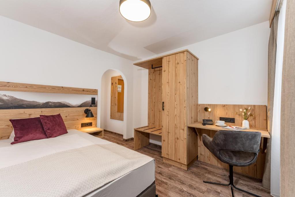 Postel nebo postele na pokoji v ubytování Hotel Hierzegger