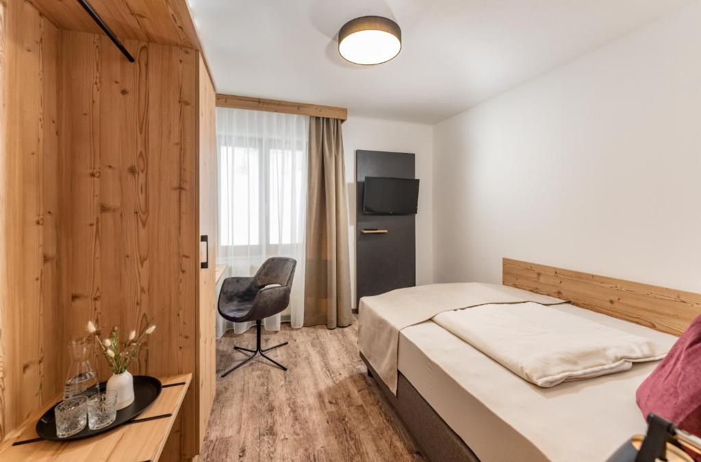 Postel nebo postele na pokoji v ubytování Hotel Hierzegger