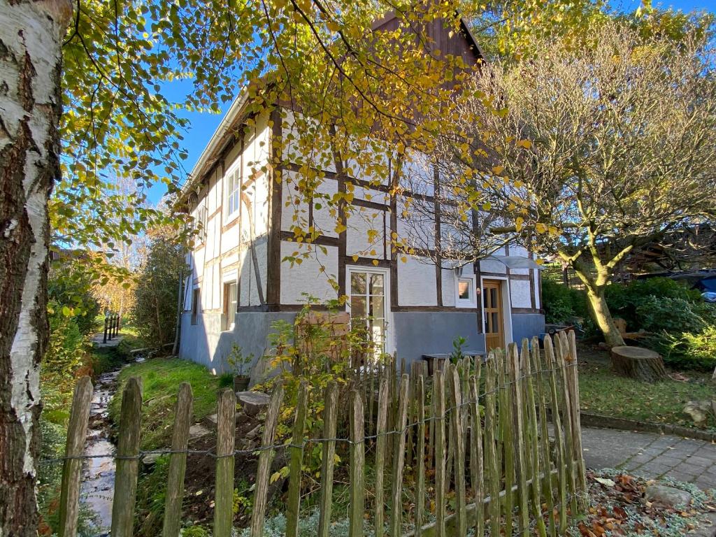 a white house with a fence in front of it at Gemütliches Ferienhaus im Extertal/ Lippe in Extertal