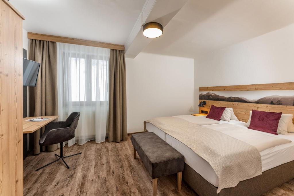 Postel nebo postele na pokoji v ubytování Hotel Hierzegger