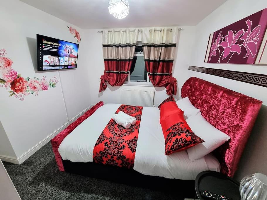 a bedroom with a bed with red and white pillows at *5SM* Setup for your most relaxed & amazing stay + Free Parking + Free Fast WiFi * in Morley