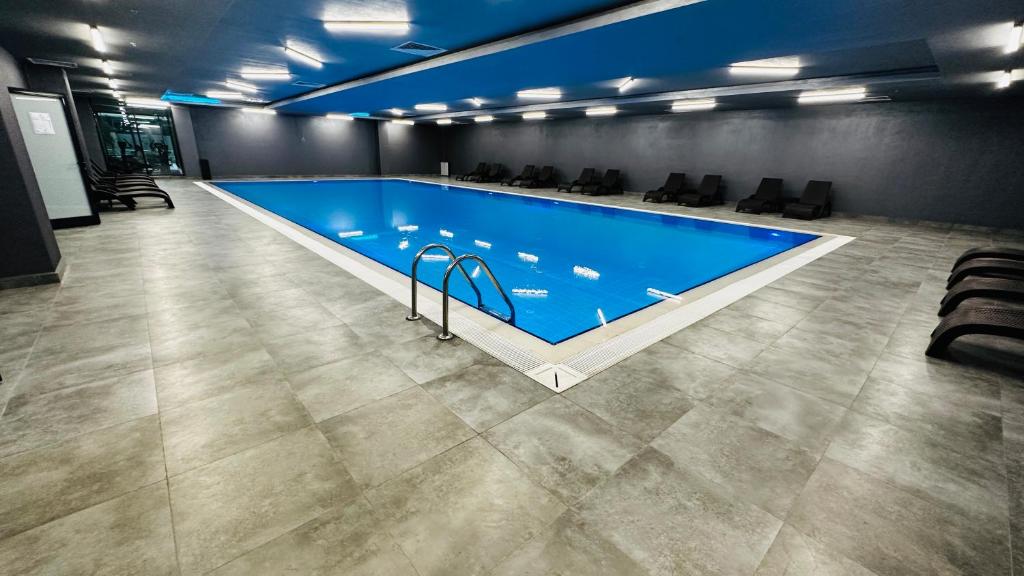 a large swimming pool in a large room at Lux Residence Next to Outlet in High Floor 26 in Istanbul