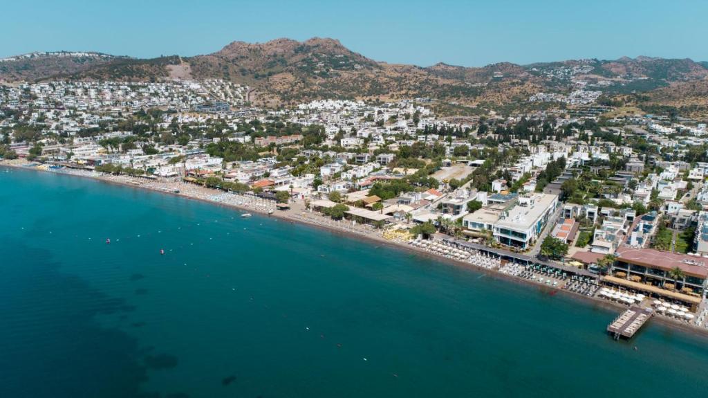 an aerial view of a beach with buildings and the water at Kefi Beach & Suites in Ortakent