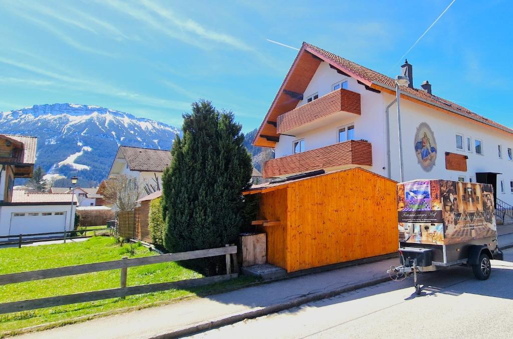 a truck parked in front of a building at Aggenstein - Helles Studio mit Südbalkon und traumhaftem Bergpanorama in Pfronten Mitte in Pfronten