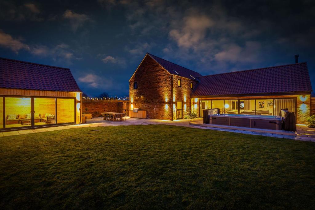 a house with a large lawn in front of it at The Birches, Ashlin Farm Barns in Lincoln