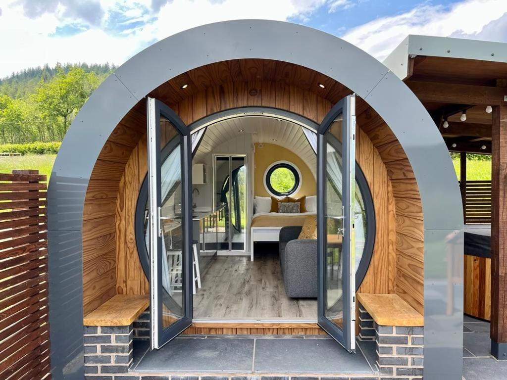 an arched entryway to a tiny house with a bedroom at Yr Onnen in Oswestry