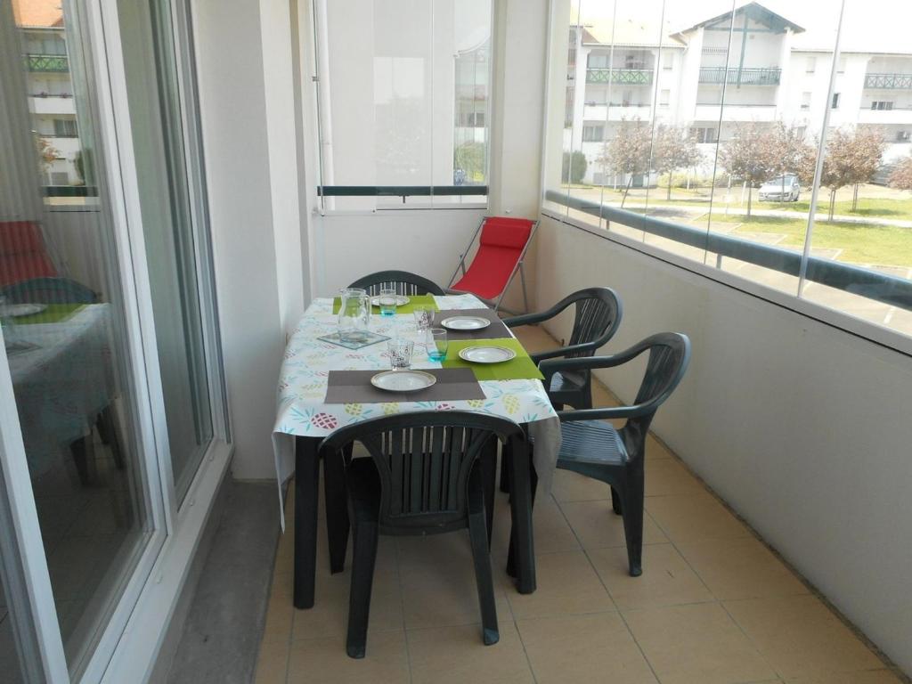 - une table et des chaises dans une chambre avec fenêtre dans l'établissement Appartement Hendaye, 2 pièces, 4 personnes - FR-1-2-291, à Hendaye