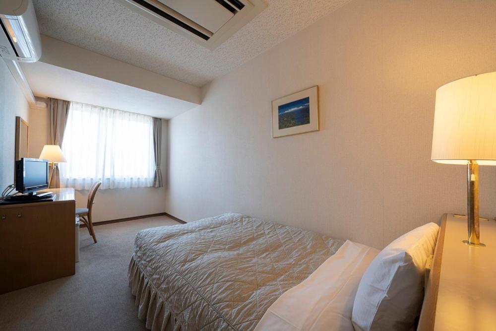 Postel nebo postele na pokoji v ubytování Seto Park Hotel