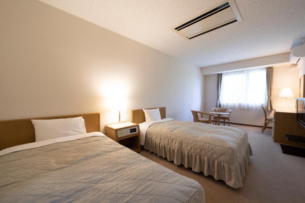 Postel nebo postele na pokoji v ubytování Seto Park Hotel