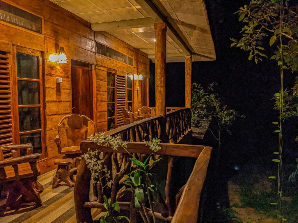 a log cabin with a porch at night at Sigiri Choona Lodge 'unique sunrise viewpoint' in Sigiriya
