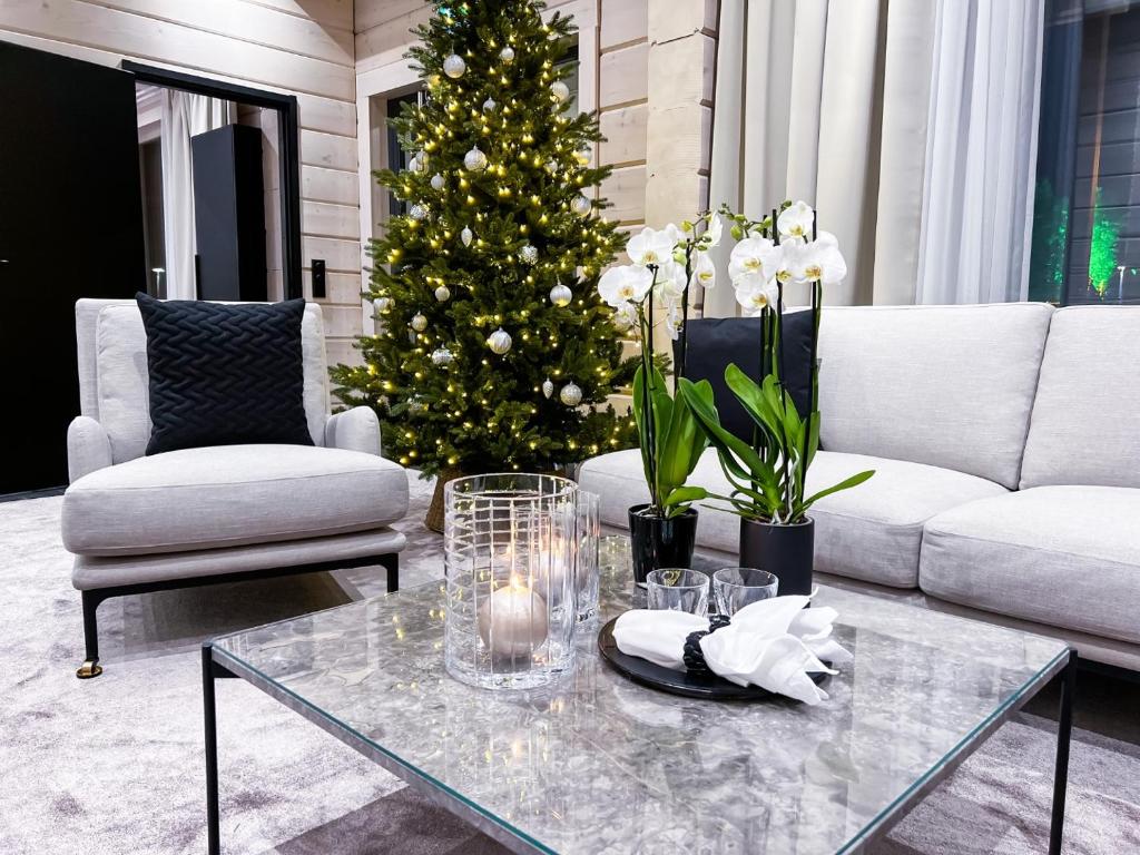 a living room with a christmas tree and a coffee table at Santa's Luxury Boutique Villa, Santa Claus Village, Apt 1 in Rovaniemi