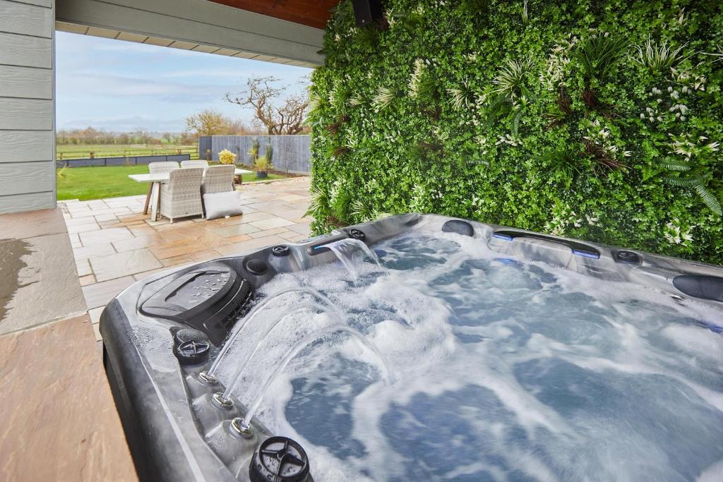 a jacuzzi tub in the backyard of a house at Host & Stay - The Stables in Yarm