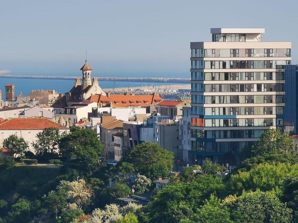 a view of a city with a tall building at Maritimo Luxury ApartHotel in Constanţa