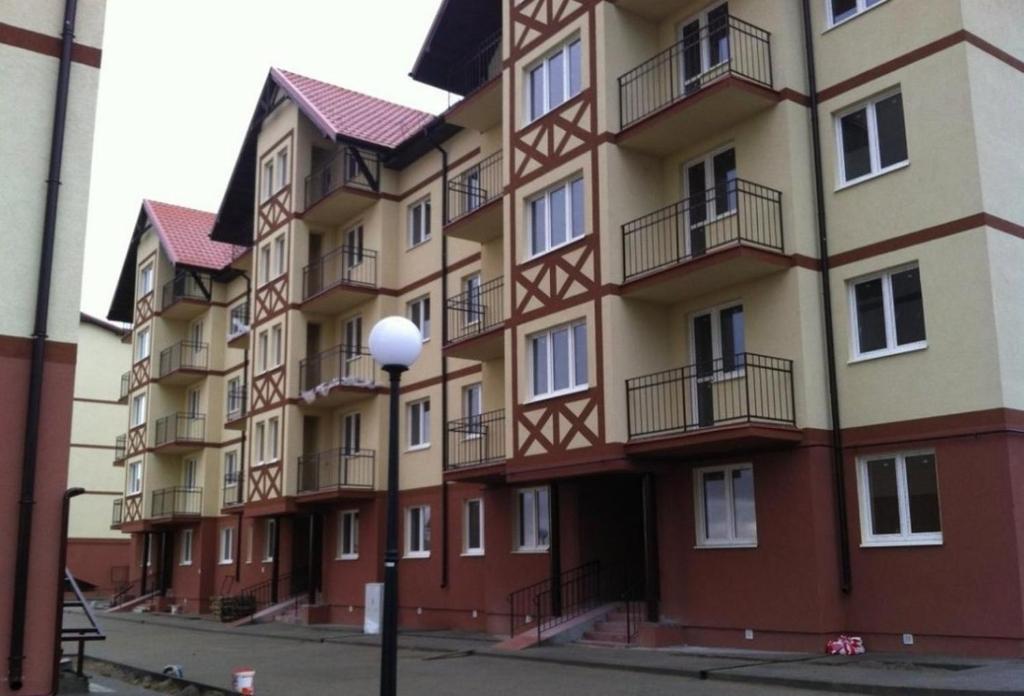 a large apartment building with balconies and a street light at Apartments on Primorskaya in Zelenogradsk