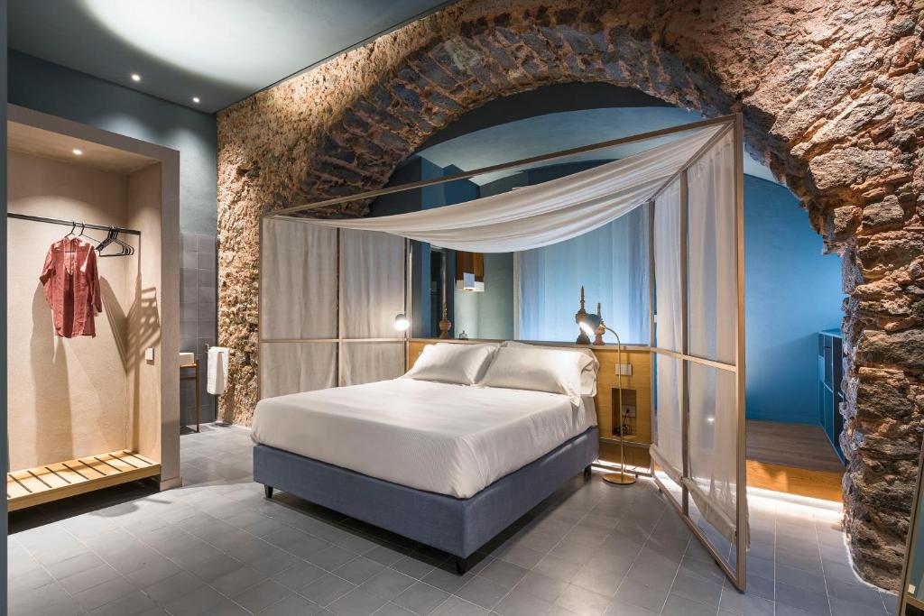 Postel nebo postele na pokoji v ubytování BASTIÒ PRIVATE SUITES
