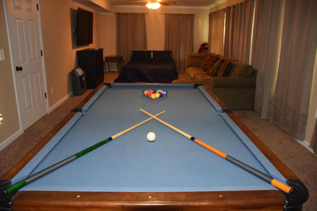 a pool table with three balls on top of it at Luxury Home Stay in Loganville