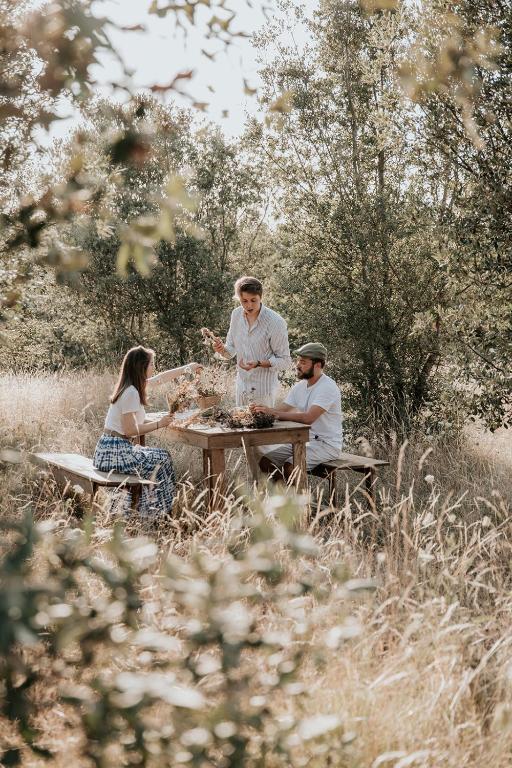 a group of people sitting around a picnic table at Domaine St-Amand in Saint-Amand-de-Coly