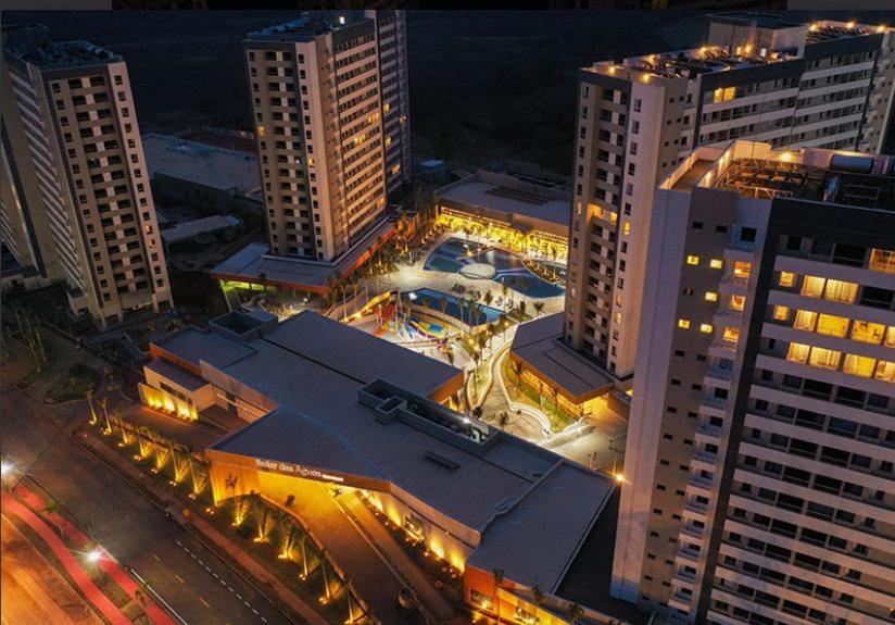 an overhead view of a city at night with buildings at Resort Solar das Águas in Olímpia