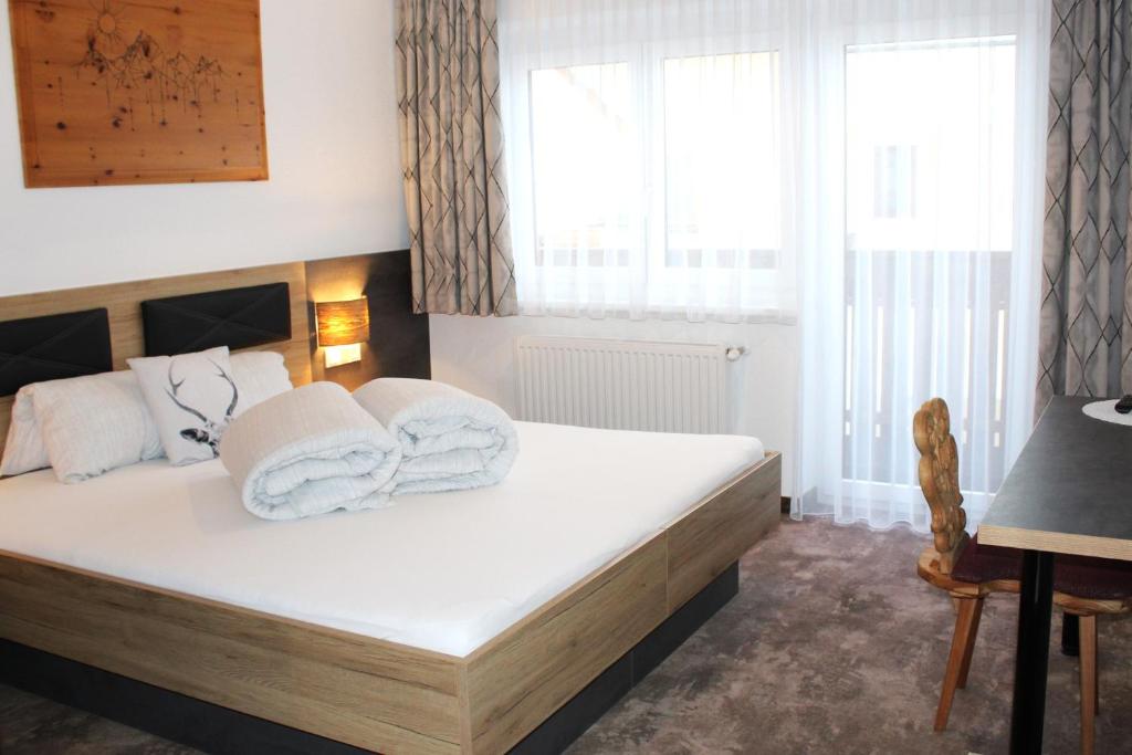 A bed or beds in a room at Apart Garni Jägerheim