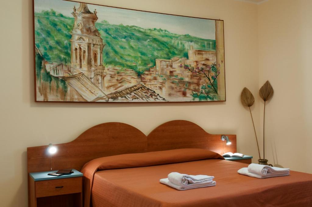 a bedroom with a bed with two towels on it at Residence Casa Del Mar Sicilia in Marina di Modica