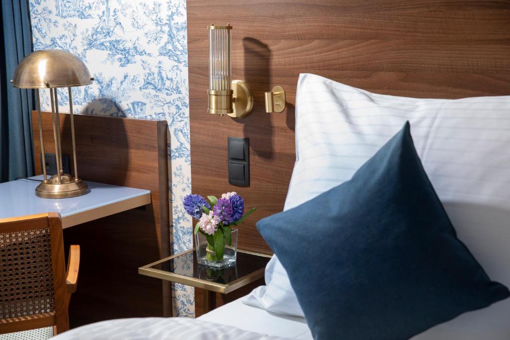 Postel nebo postele na pokoji v ubytování ARTIST Boutique Hotel