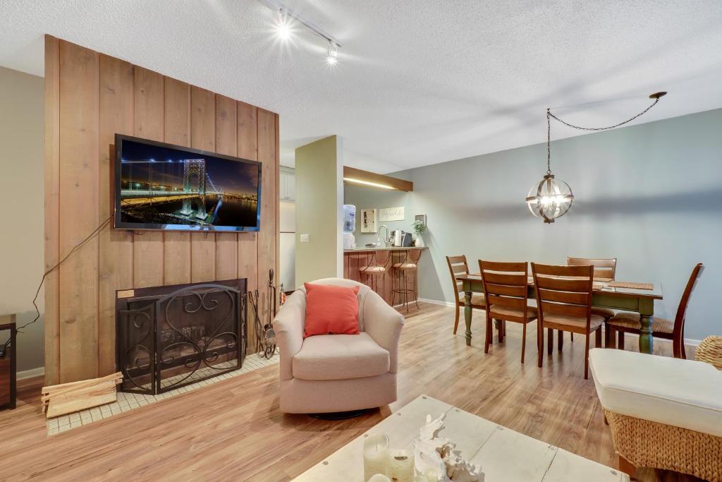 a living room with a fireplace and a dining room at Harbor Cove Shores in Harbor Springs