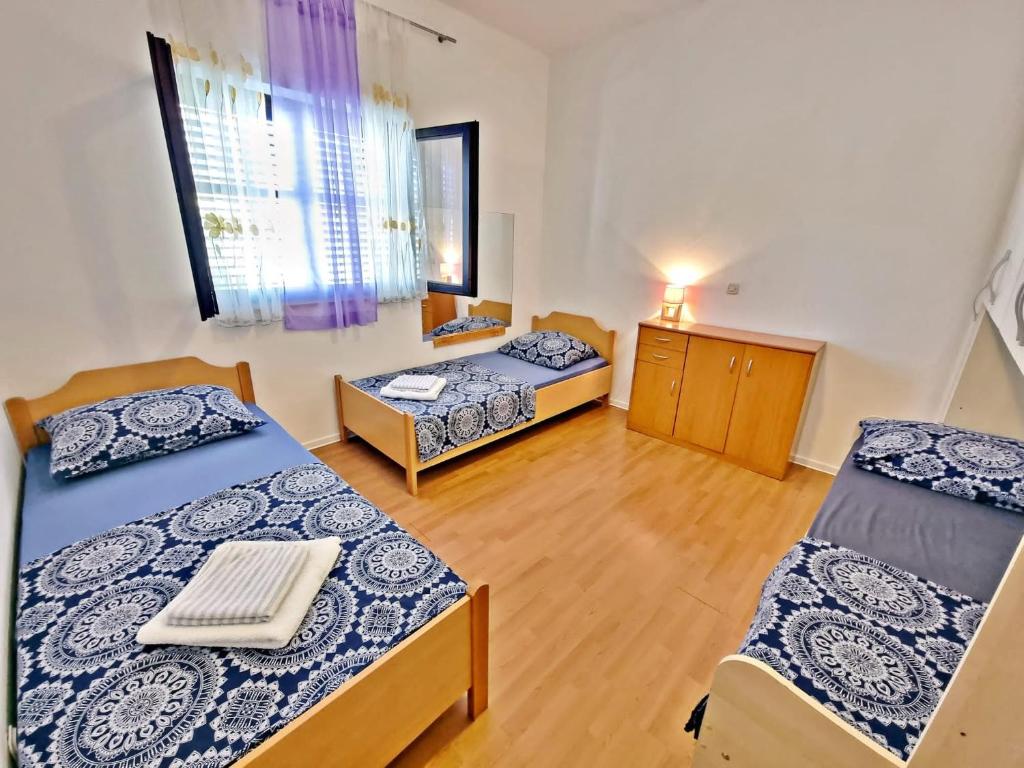 a room with two beds and a room with at Apartman Irena with terase end private parking in Okrug Donji