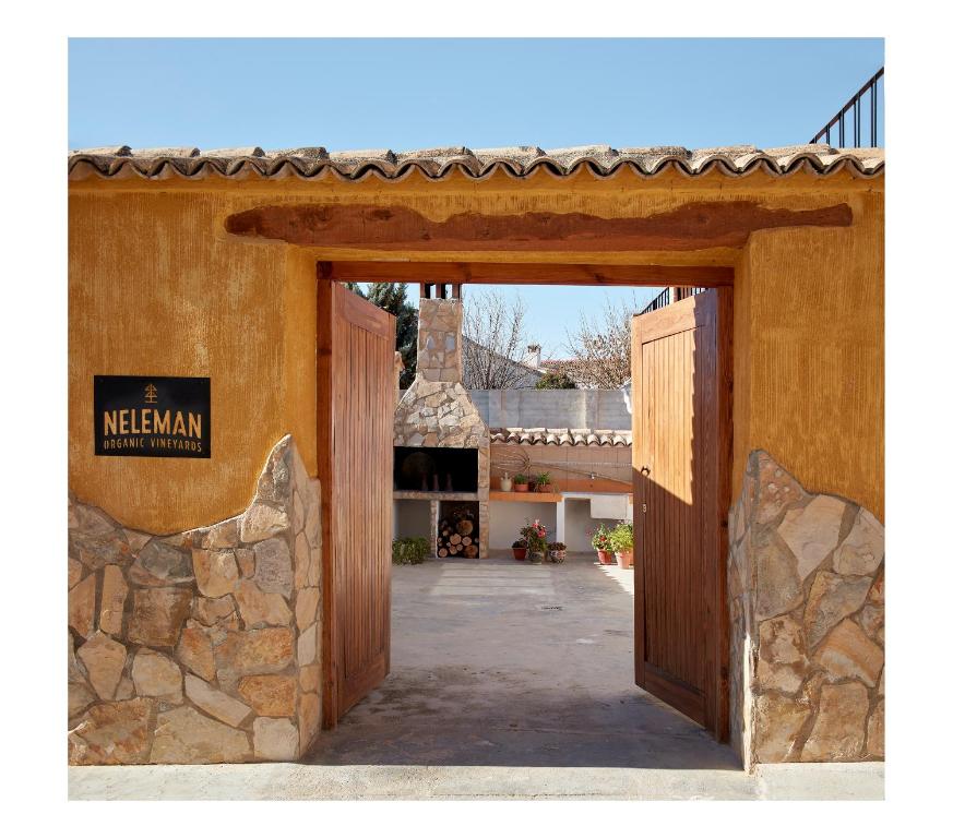 an open door to a building with a stone wall at Casa Neleman 