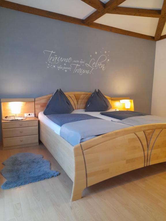 a bedroom with two beds and a sign on the wall at Haus Rosina in Mühlbach am Hochkönig