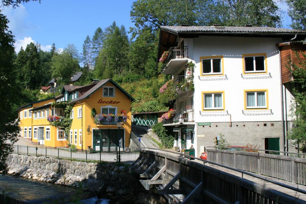 a group of buildings next to a river at Appartements Stocker - Zur Schmiede in Schladming