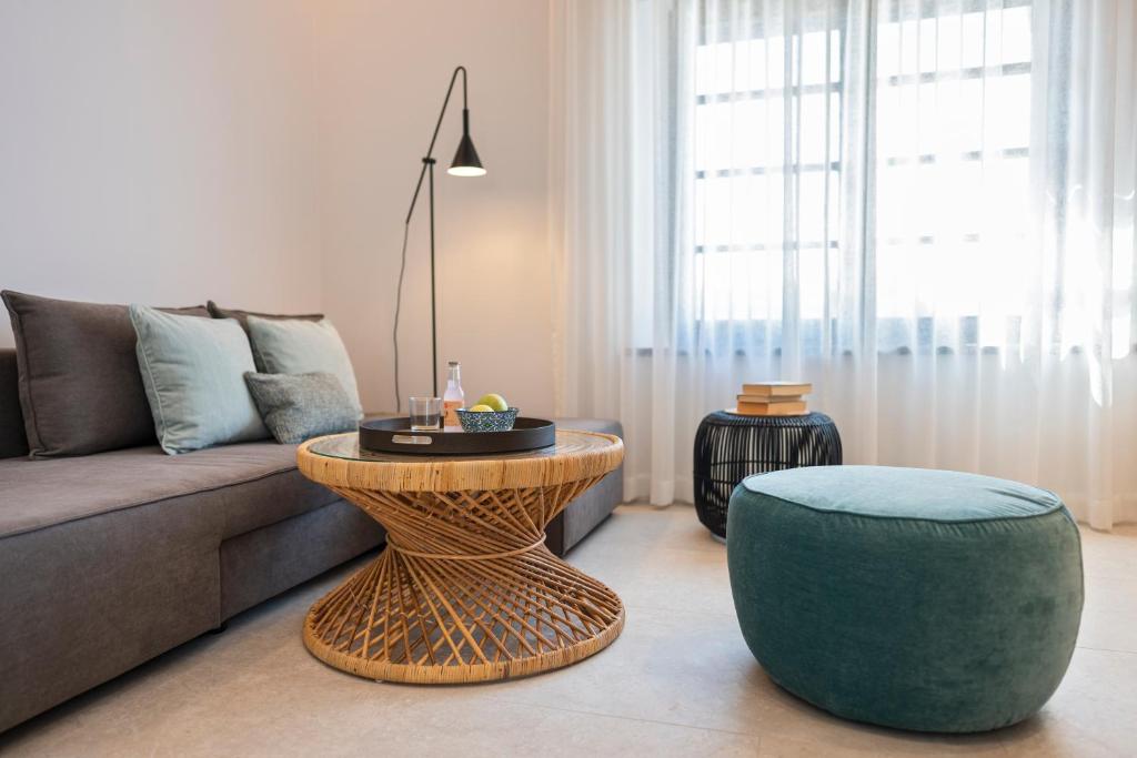 a living room with a couch and a table and a stool at Naillac Elite Suites in Rhodes Town