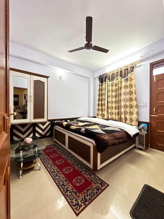a bedroom with a bed and a ceiling fan at YATIKA HOMESTAY in Shimla