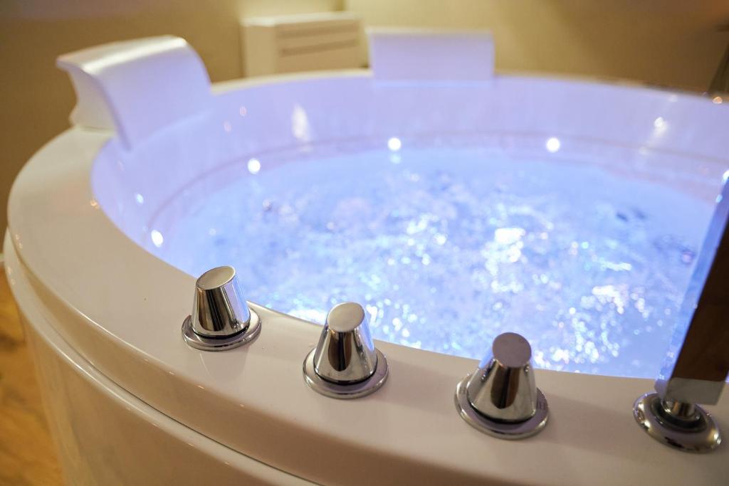 a jacuzzi bath tub with a blue water at PALAZZO TESTA - LOCAZIONE TURISTICA in Florence