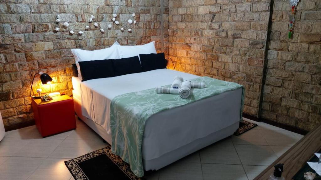 En eller flere senge i et værelse på Recreio - CorAll Residence - 2 Quartos e 1 Suíte