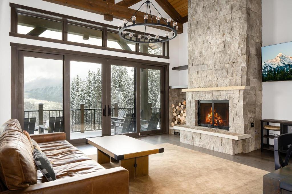 a living room with a couch and a fireplace at 360 Chalet in Big Sky