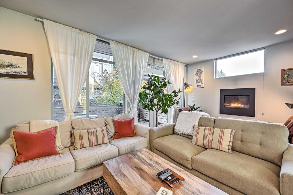 a living room with two couches and a coffee table at Sleek Seattle Home with Rooftop Patio and Views! in Seattle