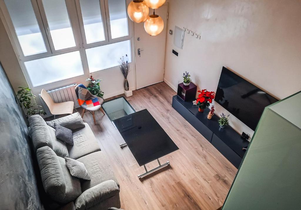 an overhead view of a living room with a couch and a tv at Tofi in Madrid