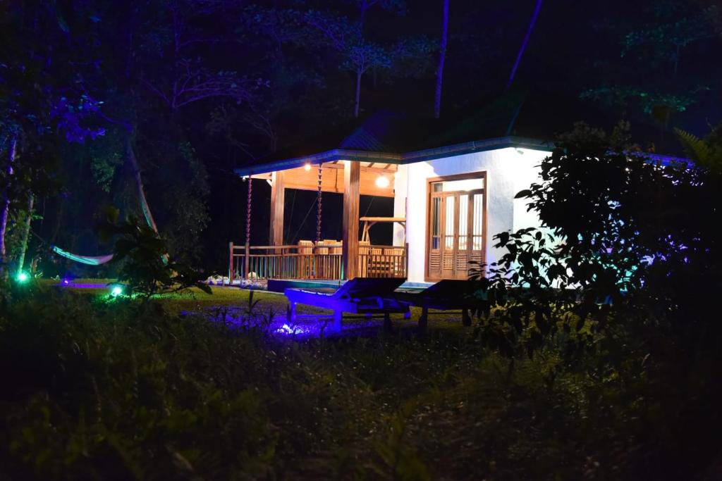 a small house at night with blue lights at Villa Green Ice in Galle