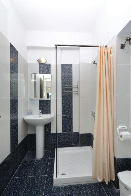 a bathroom with a shower and a sink at Pelagos in Stafylos