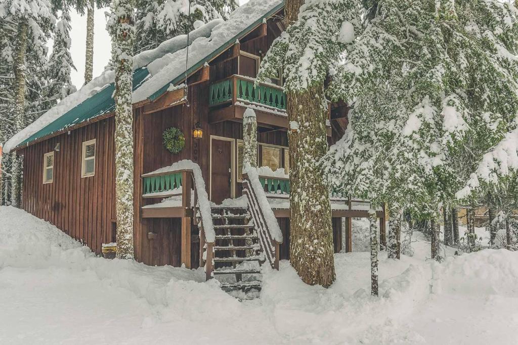 a log cabin in the snow with a snow covered at Moosewood Cabin in Government Camp
