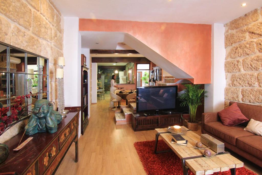 a living room with a couch and a tv at Casa Marrón Boutique Home in Benissa